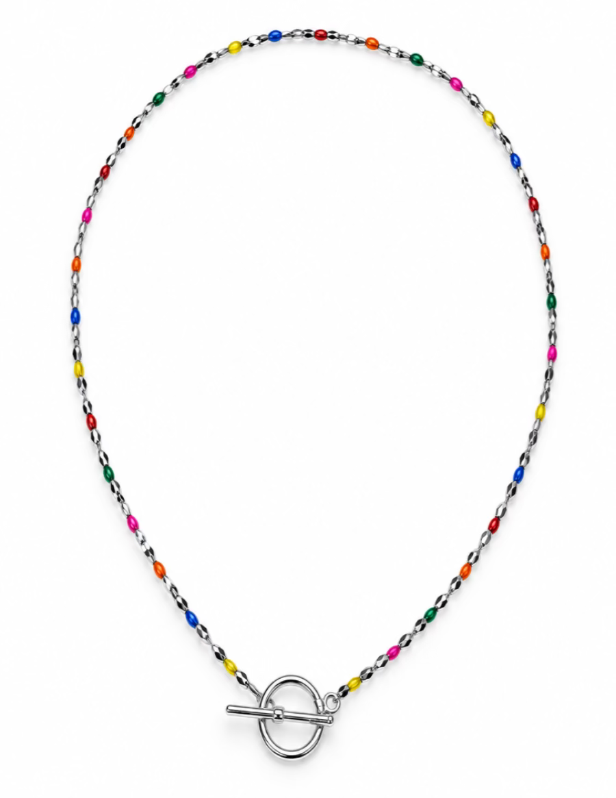 A delicate beaded necklace with a silver toggle clasp, featuring small multicolored beads on a silver chain, displayed on a neutral gray background.